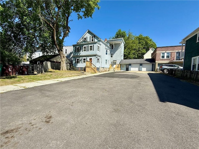 172 Park Ave, Woonsocket, RI 02895 - view of front of house with fence and a garage