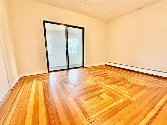 172 Park Ave, Woonsocket, RI 02895 - empty room with a textured ceiling, baseboards, and a baseboard heating unit