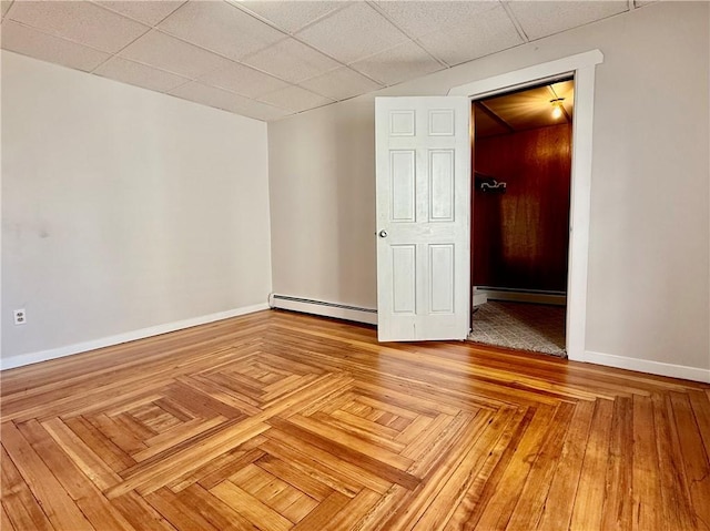 172 Park Ave, Woonsocket, RI 02895 - unfurnished room with baseboards, a baseboard radiator, and a drop ceiling