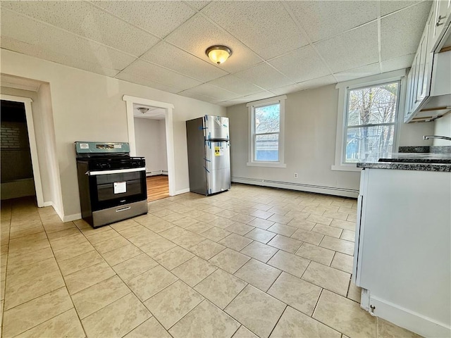172 Park Ave, Woonsocket, RI 02895 - kitchen featuring light tile patterned flooring, baseboards, a drop ceiling, baseboard heating, and stainless steel appliances