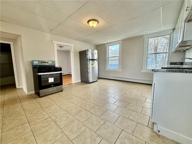 172 Park Ave, Woonsocket, RI 02895 - kitchen featuring appliances with stainless steel finishes, a paneled ceiling, baseboards, light tile patterned floors, and a baseboard radiator