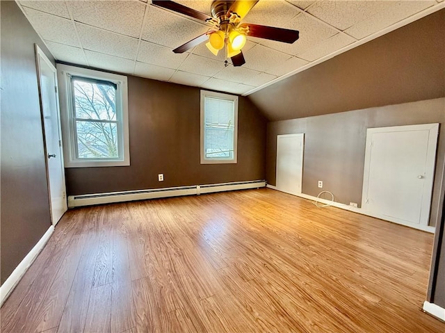 172 Park Ave, Woonsocket, RI 02895 - additional living space with baseboards, a ceiling fan, wood finished floors, and baseboard heating