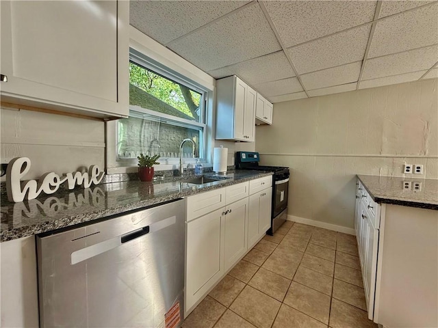 172 Park Ave, Woonsocket, RI 02895 - kitchen featuring a drop ceiling, dark stone counters, white cabinets, a sink, and appliances with stainless steel finishes