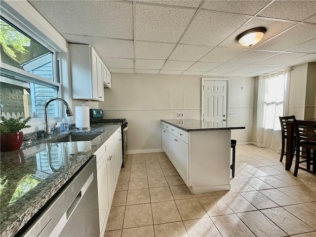 172 Park Ave, Woonsocket, RI 02895 - kitchen with a sink, stainless steel appliances, a drop ceiling, and white cabinetry