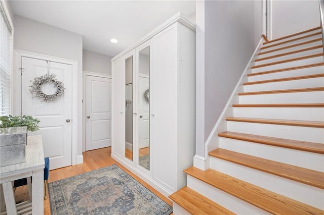 stairs featuring recessed lighting and wood finished floors