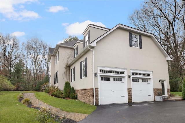 view of home's exterior with aphalt driveway, stone siding, stucco siding, a yard, and a garage