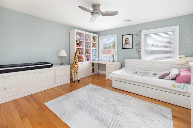 sitting room with a ceiling fan, visible vents, and light wood-type flooring