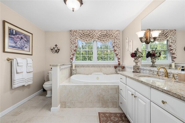 39 Greenbriar Rd, West Warwick, RI 02893 - full bath with an inviting chandelier, tile patterned flooring, vanity, toilet, and a garden tub