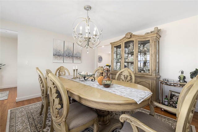 39 Greenbriar Rd, West Warwick, RI 02893 - dining space with baseboards, wood finished floors, and a notable chandelier