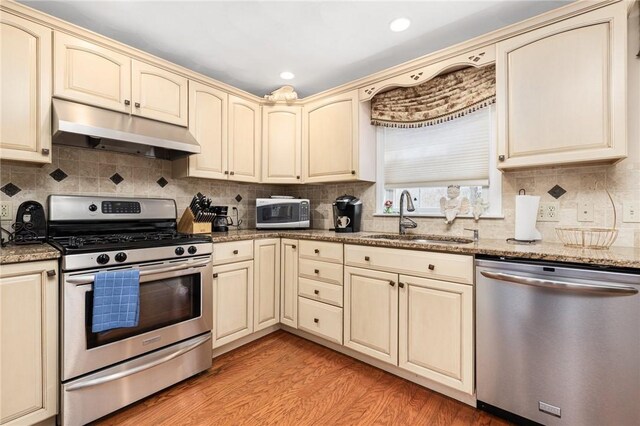 39 Greenbriar Rd, West Warwick, RI 02893 - kitchen with a sink, cream cabinets, stainless steel appliances, and under cabinet range hood
