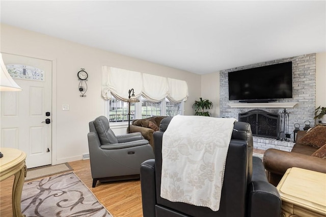 39 Greenbriar Rd, West Warwick, RI 02893 - living area with light wood-type flooring, baseboards, and a fireplace