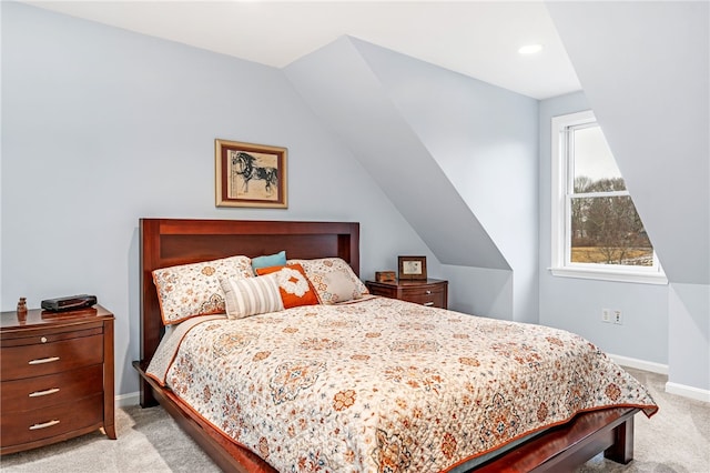 carpeted bedroom featuring baseboards and vaulted ceiling