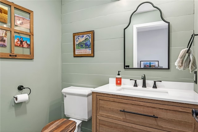 half bath featuring toilet and vanity