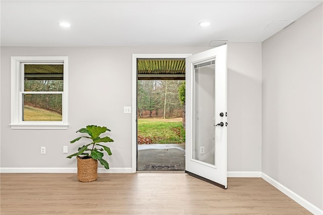 foyer with recessed lighting, wood finished floors, and a wealth of natural light