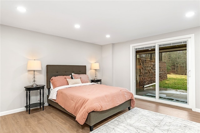 bedroom featuring light wood-style floors, recessed lighting, baseboards, and access to exterior