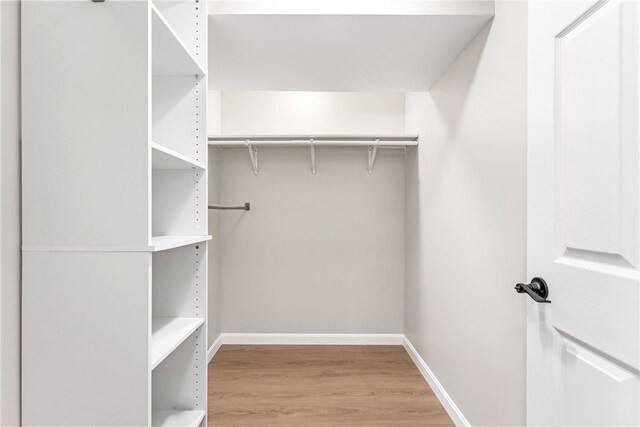 spacious closet with wood finished floors