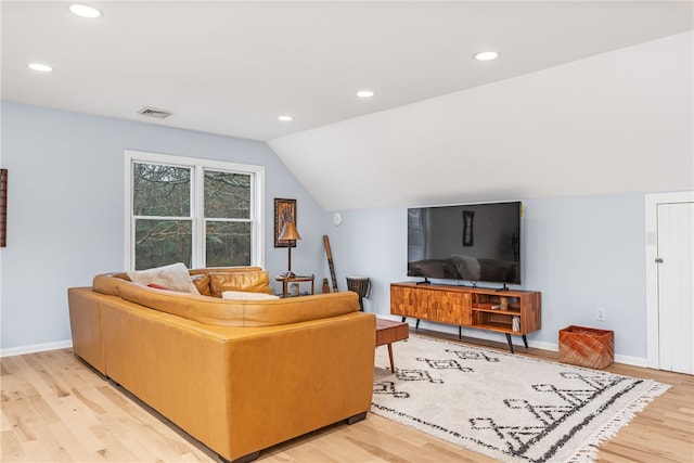 living area with visible vents, recessed lighting, light wood-style floors, and vaulted ceiling
