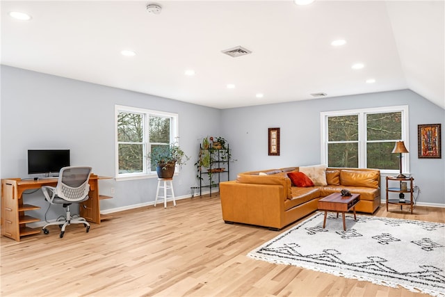 living area featuring a wealth of natural light, recessed lighting, wood finished floors, and visible vents