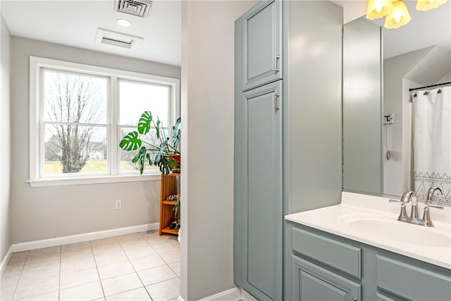 bathroom featuring tile patterned flooring, a wealth of natural light, vanity, and visible vents