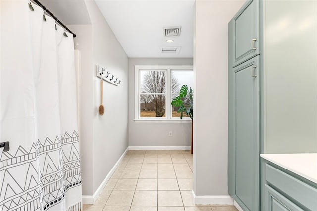 interior space with visible vents, baseboards, and light tile patterned flooring