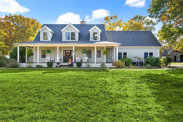view of front of property featuring a front lawn, covered porch, and a chimney