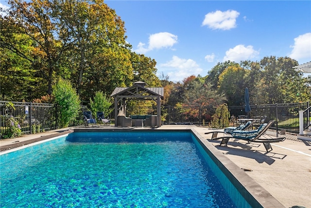 view of swimming pool featuring a fenced in pool, fence, a gazebo, and an outdoor living space