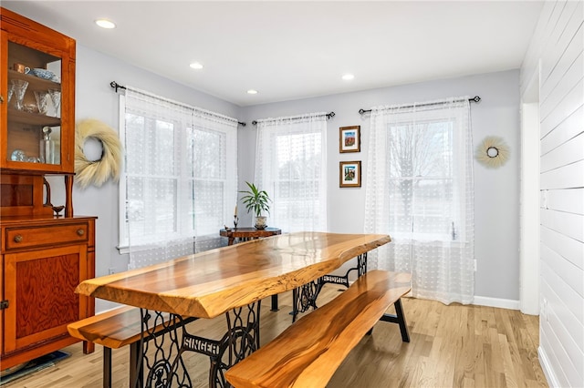dining room with recessed lighting, baseboards, and light wood finished floors