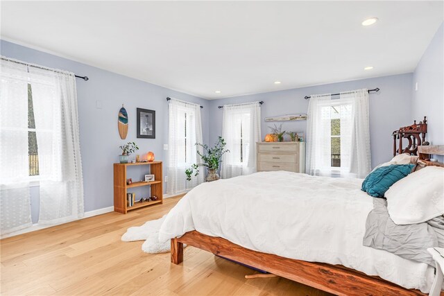 bedroom featuring baseboards, recessed lighting, and wood finished floors