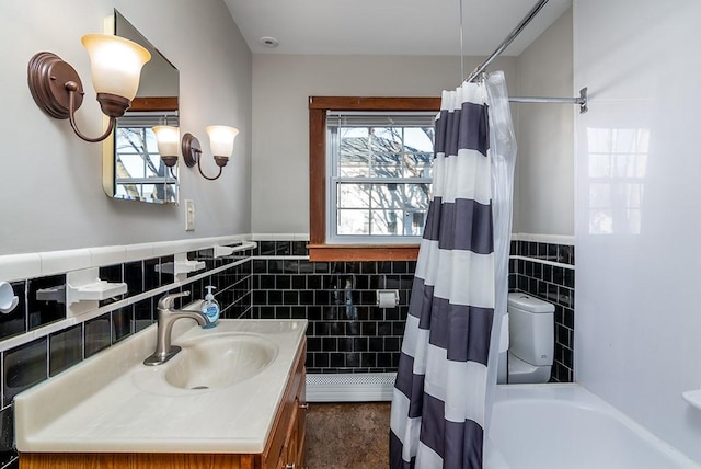 full bathroom featuring a shower with curtain, tile walls, and a healthy amount of sunlight