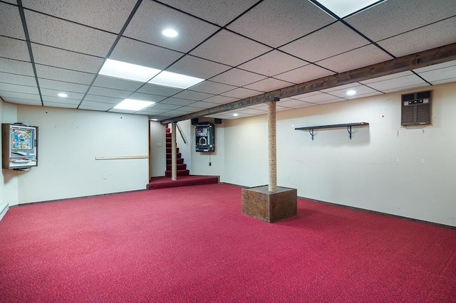finished basement featuring carpet floors, recessed lighting, stairs, and a paneled ceiling