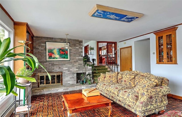 living room featuring a brick fireplace, crown molding, and stairway