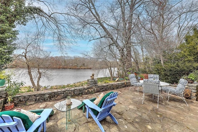 view of patio / terrace with outdoor dining space and a water view
