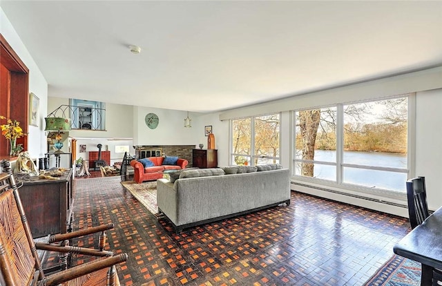 living room with a fireplace, a water view, and a baseboard radiator