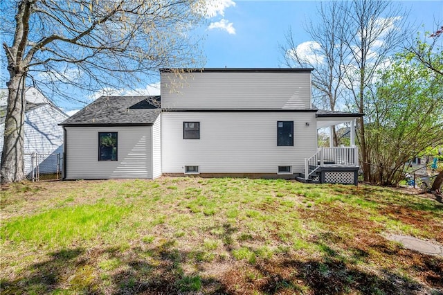 rear view of property with a lawn, fence, and covered porch