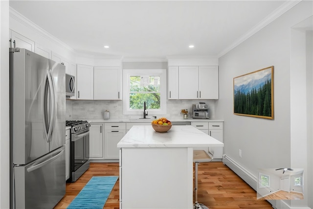 kitchen featuring a sink, a center island, stainless steel appliances, and light wood-type flooring