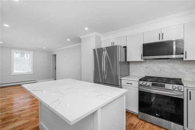 kitchen with crown molding, light wood-style floors, a center island, stainless steel appliances, and a baseboard radiator