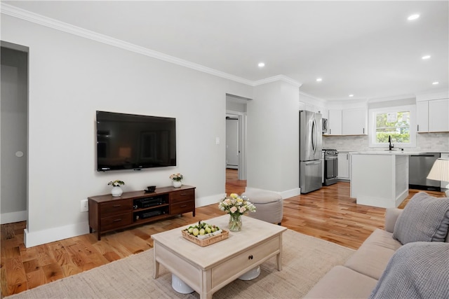 living room with crown molding, recessed lighting, baseboards, and light wood-type flooring