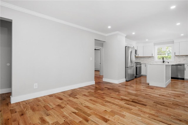 unfurnished living room with recessed lighting, baseboards, ornamental molding, and light wood finished floors