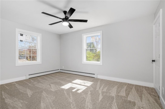 carpeted spare room featuring baseboards, ceiling fan, and a baseboard heating unit