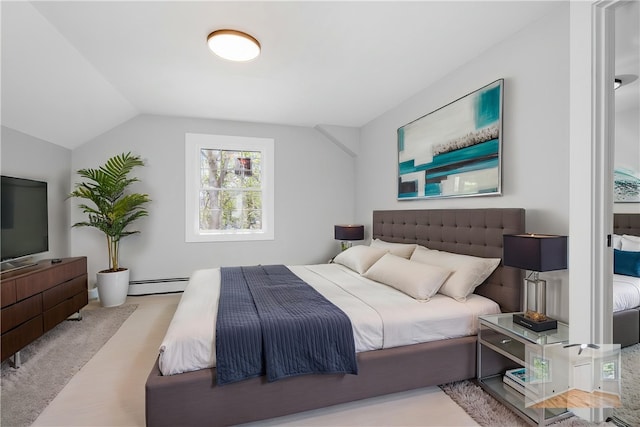 bedroom with a baseboard radiator and vaulted ceiling