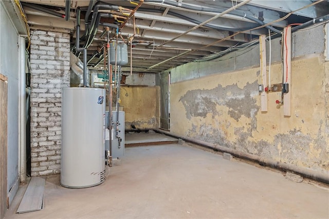 unfinished below grade area featuring a heating unit and water heater