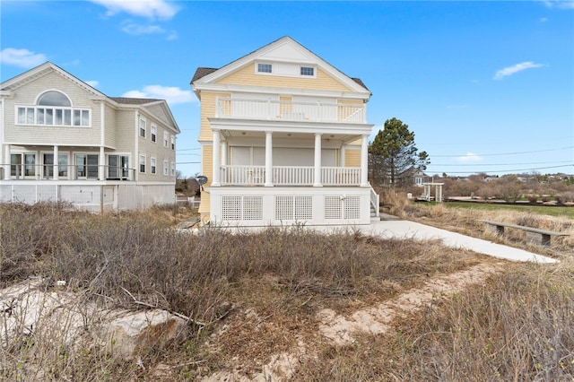 view of front of property featuring a balcony and covered porch