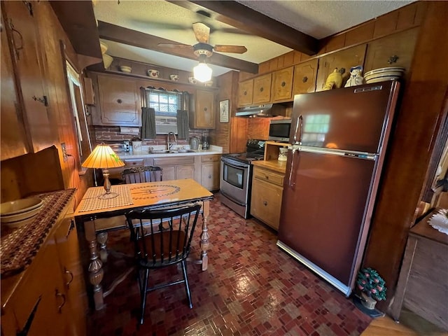 kitchen featuring appliances with stainless steel finishes, beam ceiling, a sink, a ceiling fan, and under cabinet range hood