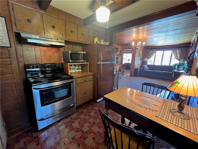 kitchen with ceiling fan with notable chandelier, brick floor, stainless steel appliances, and under cabinet range hood