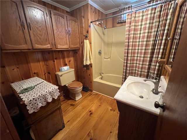 bathroom with crown molding, wood walls, toilet, shower / tub combo with curtain, and hardwood / wood-style floors