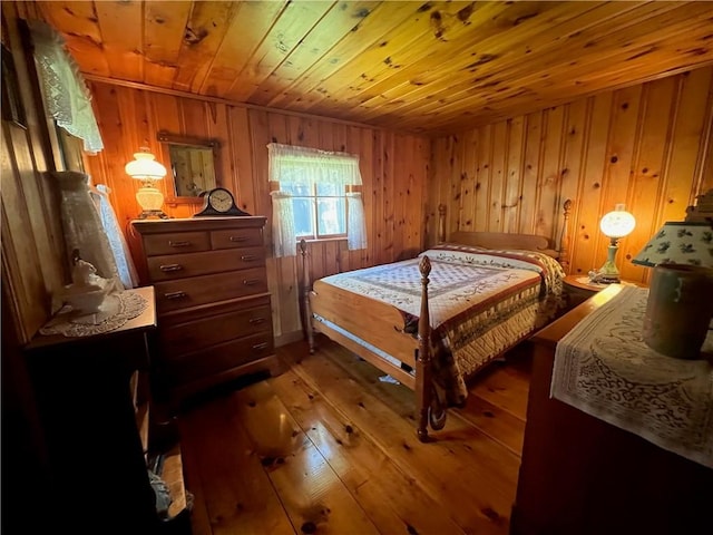 bedroom with wood walls, wooden ceiling, and hardwood / wood-style floors