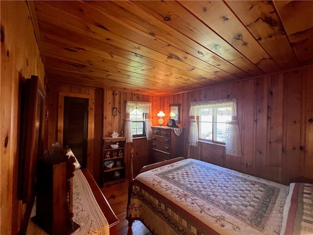 bedroom featuring wooden ceiling and wood walls