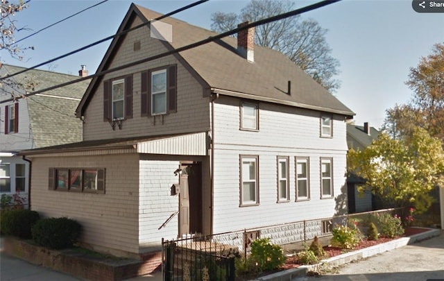 view of front of house featuring a chimney