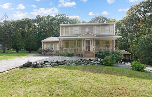 view of front of property with a porch and a front lawn