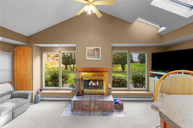 living room with carpet floors, a baseboard heating unit, and a tile fireplace